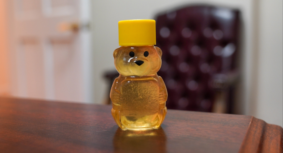 container of honey shaped like a bear