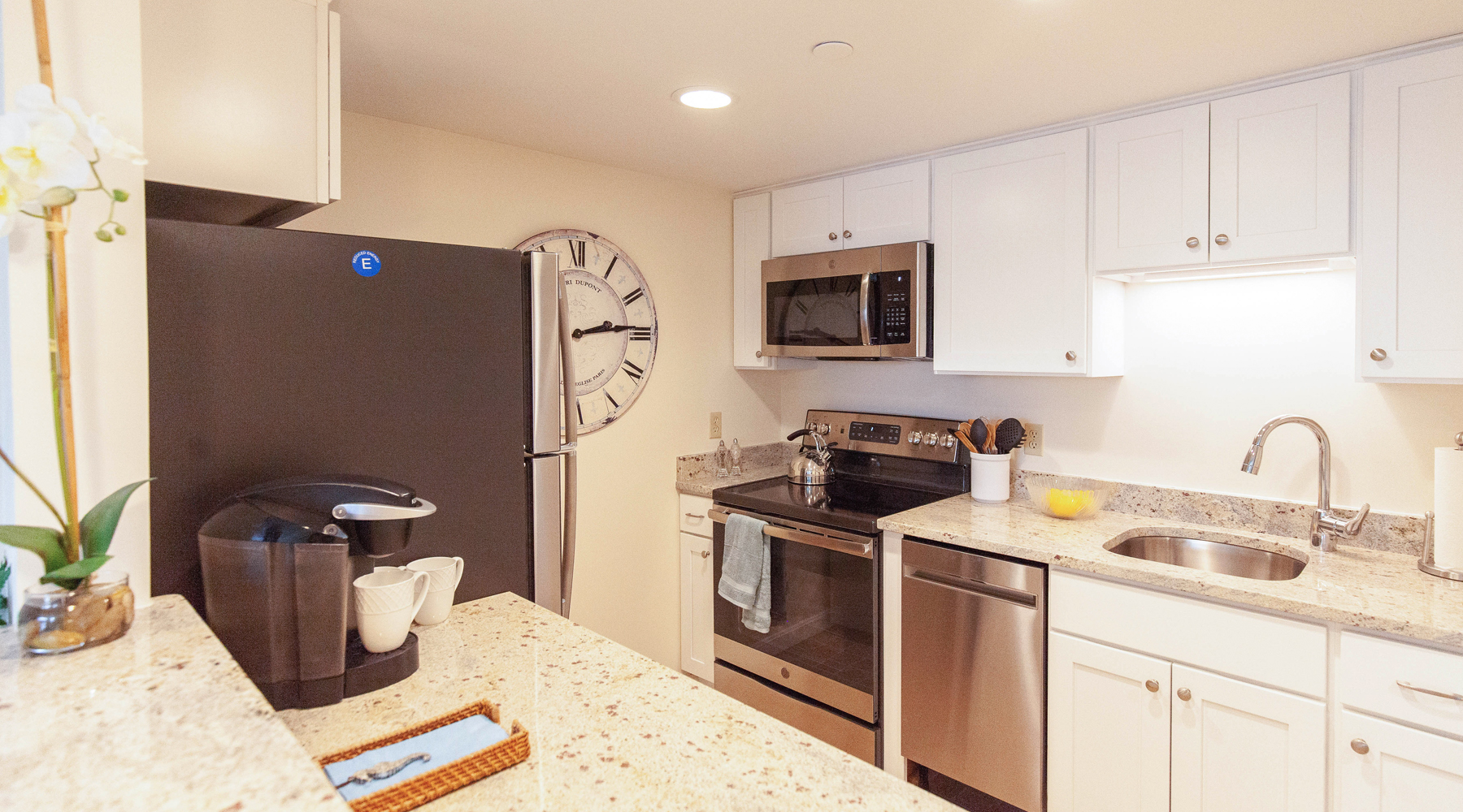 a modern galley kitchen with stone countertops