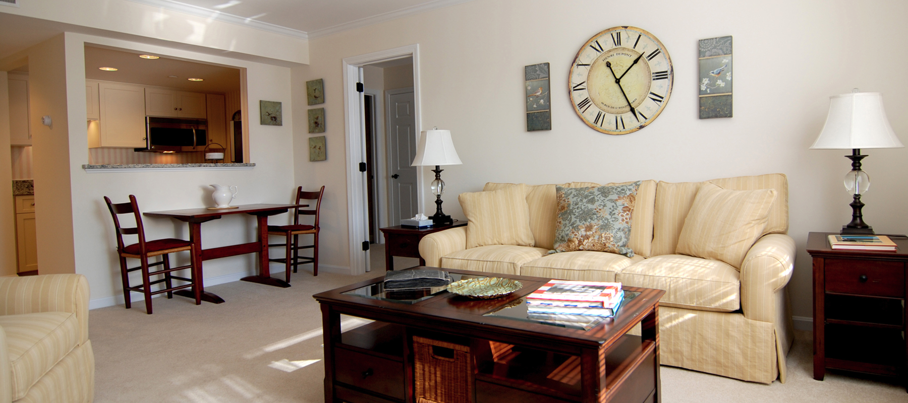 Thirwood Place living room interior with modern furniture and a large clock on the wall above the couch