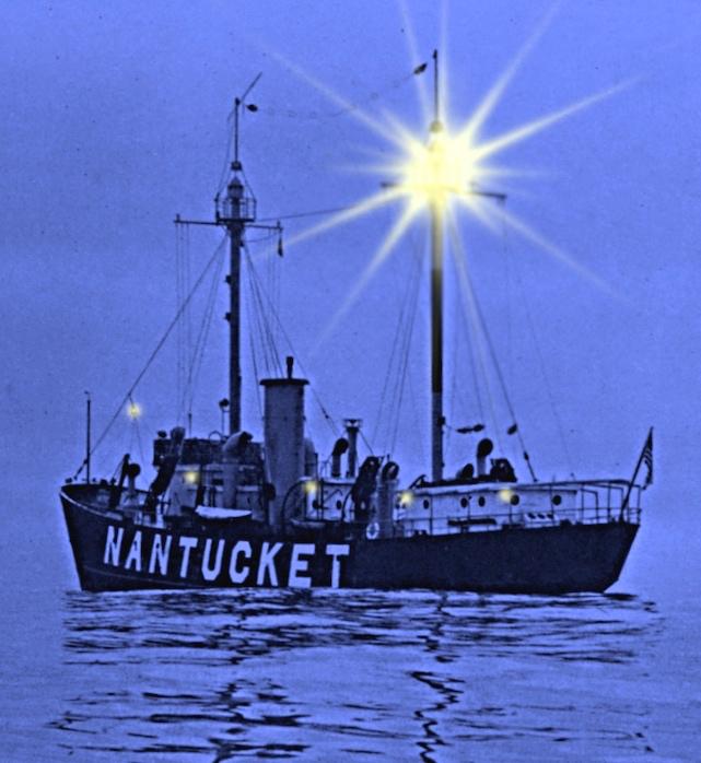 A lightship labeled NANTUCKET floats on calm water at dusk, with a bright light shining from its mast.