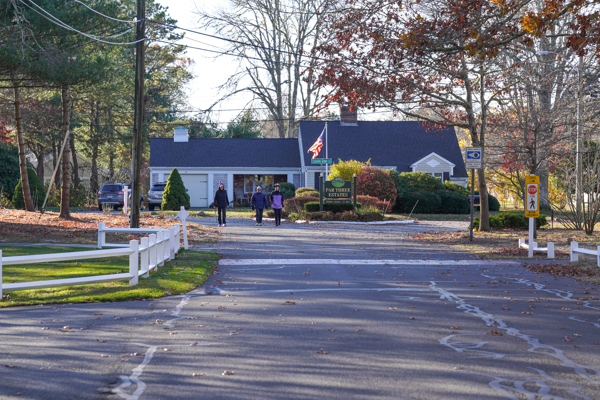 three women walking in a suburban neighborhood on a fall day