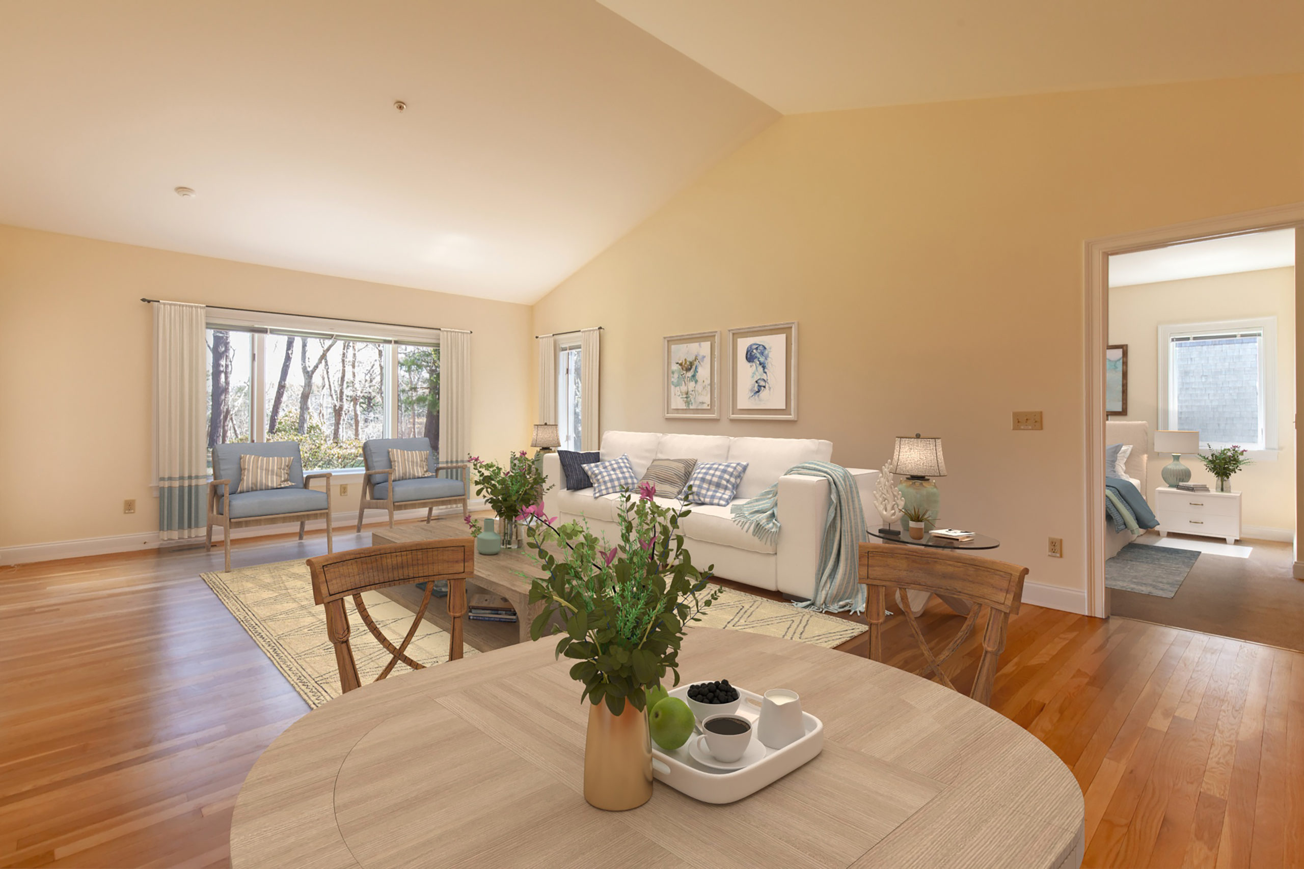 interior of contemporary apartment with wood floors and coastal decor, with a view of trees out the window